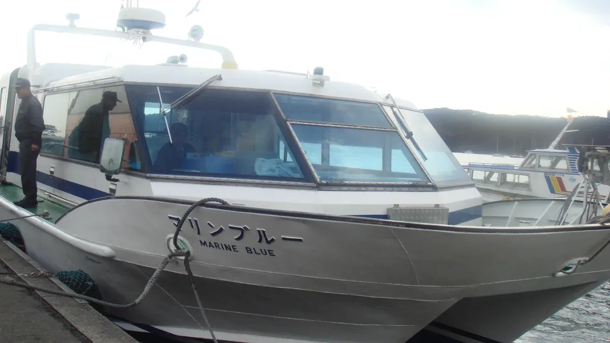 A white sightseeing boat named Marine Blue moored at a Matsushima pier